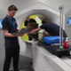 Radiographers standing around a treatment machine.