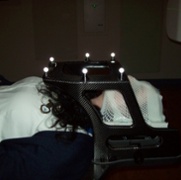 A person lying down with various fittings over their face.