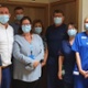 A group of clinicians stand with masks on.