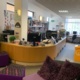 The reception desk and corridors of books at the library.