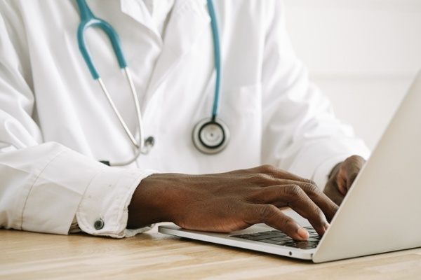 A consultant uses a laptop.