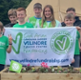 A group of people hold a flag for Velindre.