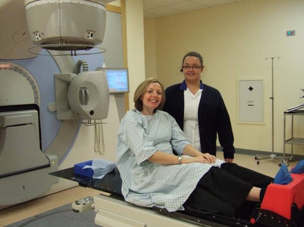 Radiographer in treatment room with patient