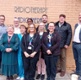 Group photo of the people named in caption standing in front of Radiotherapy building