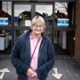 A woman is smiling outside Velindre Cancer Centre.