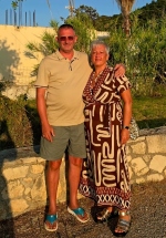 Two people are smiling in the sunshine.