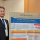 Mark is stood next to his conference poster. Two colleagues are also there.