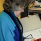 A woman is looking at paperwork and records.