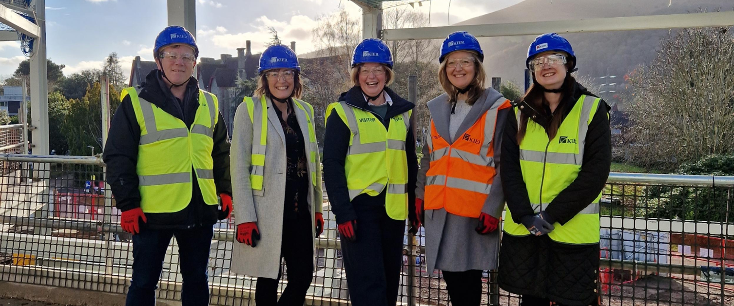 A group of Velindre staff stand in a building site.