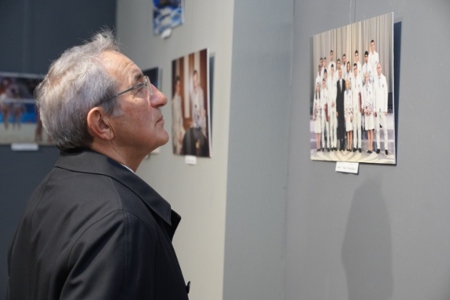 A man is looking at an art exhibition.