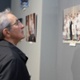 A man is looking at an art exhibition.