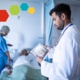 A patient receiving care from medical professionals on a hospital ward.